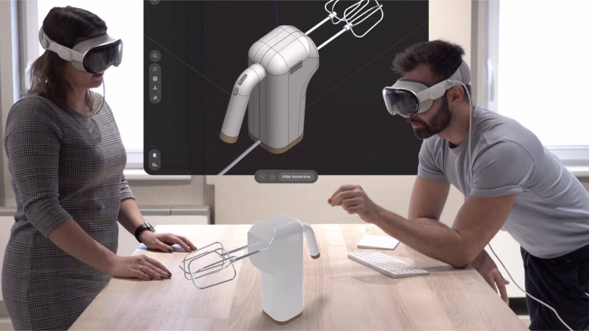 Two people each wearing a Vision Pro, virtual content rendered on a desk between them